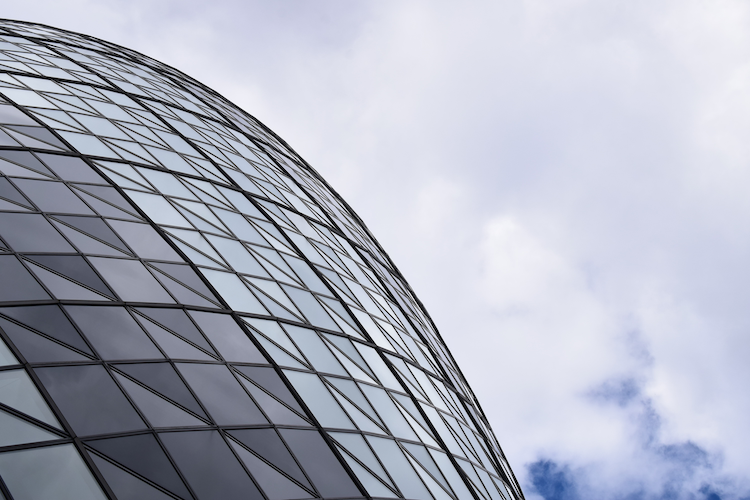 A close-up architectural detail of the Gherkin building in London, showcasing its iconic curved glass facade with triangular patterns. The reflective glass panels create a dynamic interplay of light and shadow, while the geometric design emphasizes the structure's modern and innovative engineering. Set against a partly cloudy sky, the composition highlights the Gherkin's sleek and futuristic aesthetic. Captured on a Nikon D5300 digital camera. A work by John Paglia.